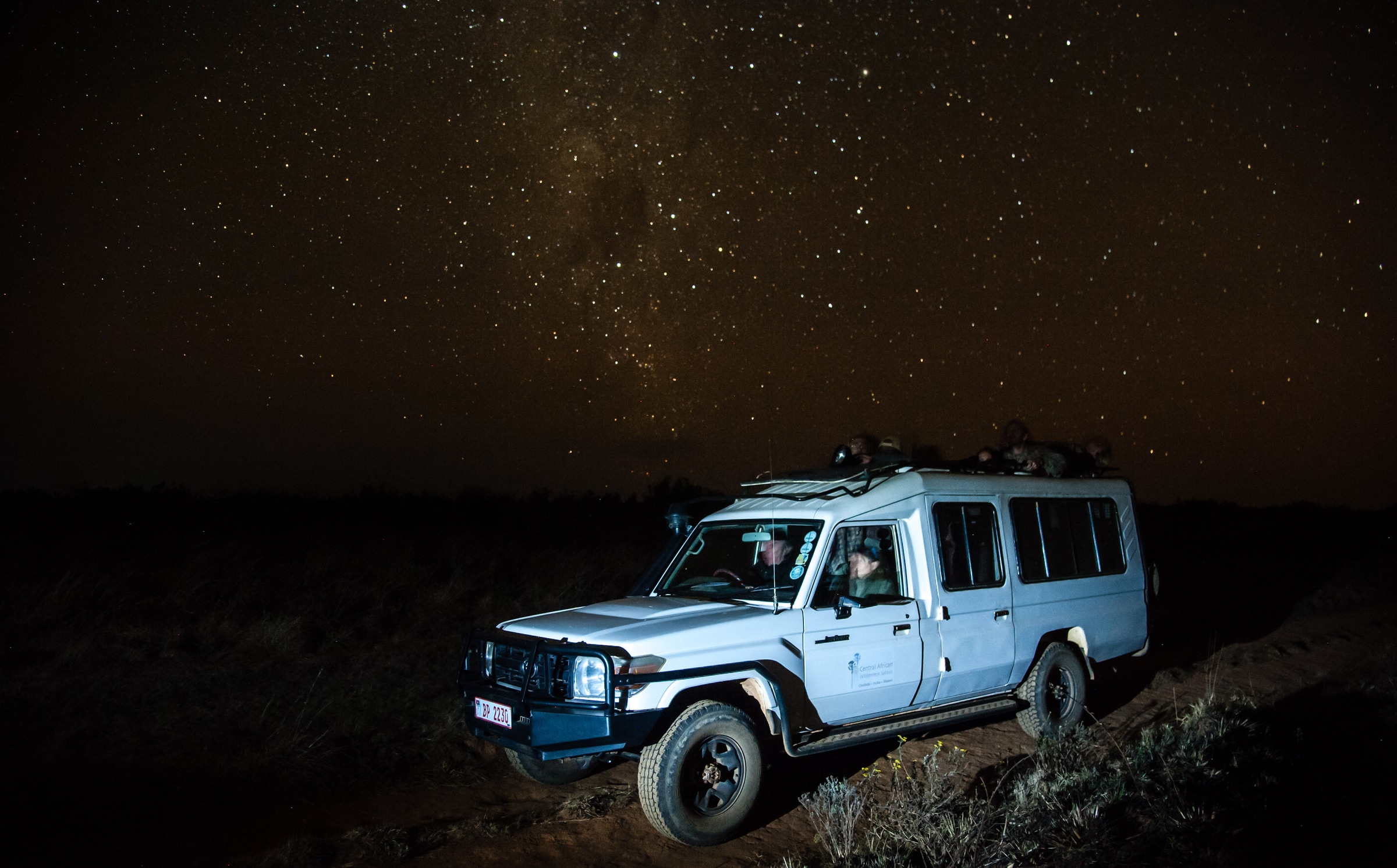 A safari vehicle beneath a star-filled sky at Chelinda.
