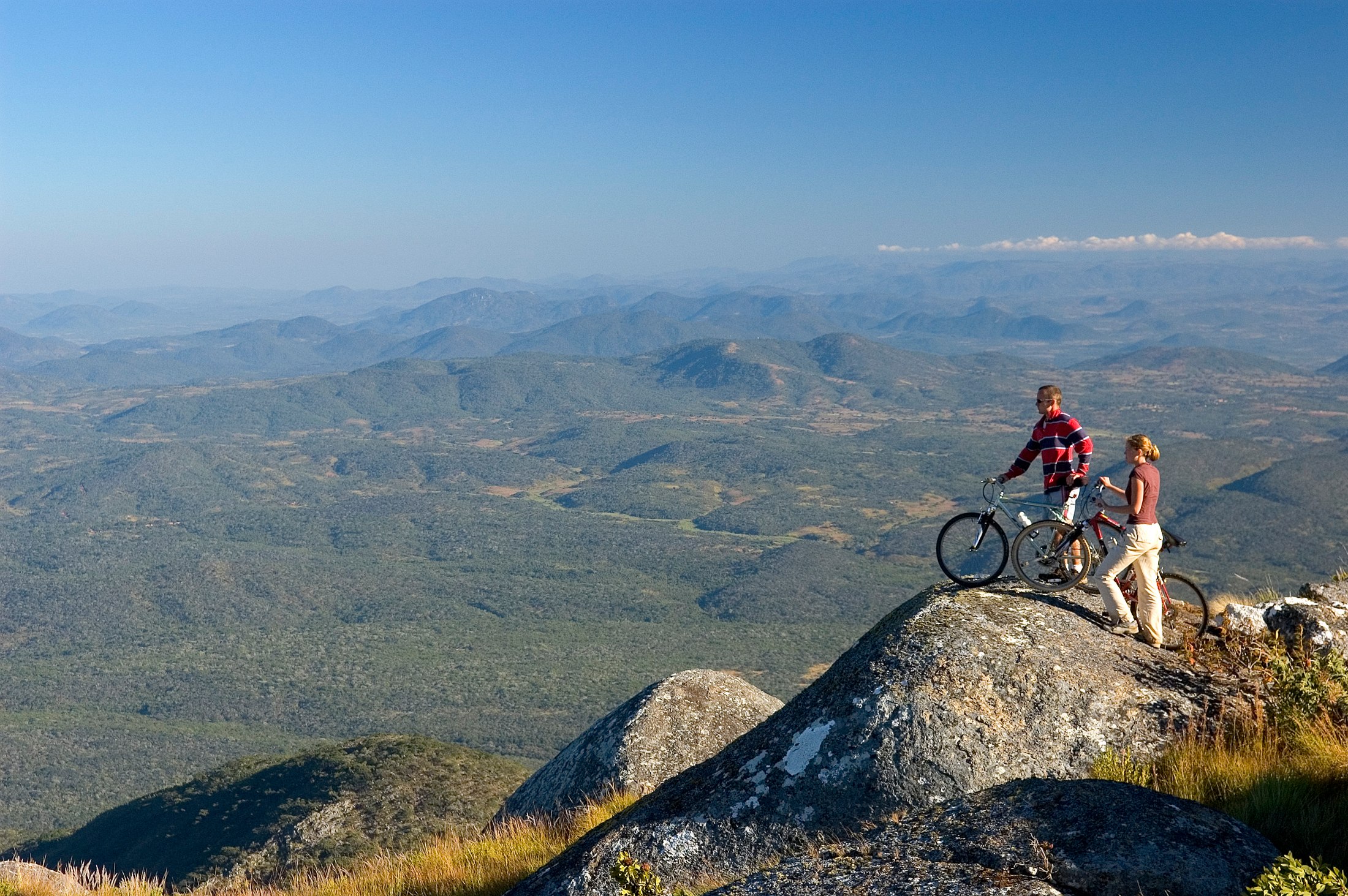 Mountain bikers at a viewpoint overlooking the Nyika landscape.
