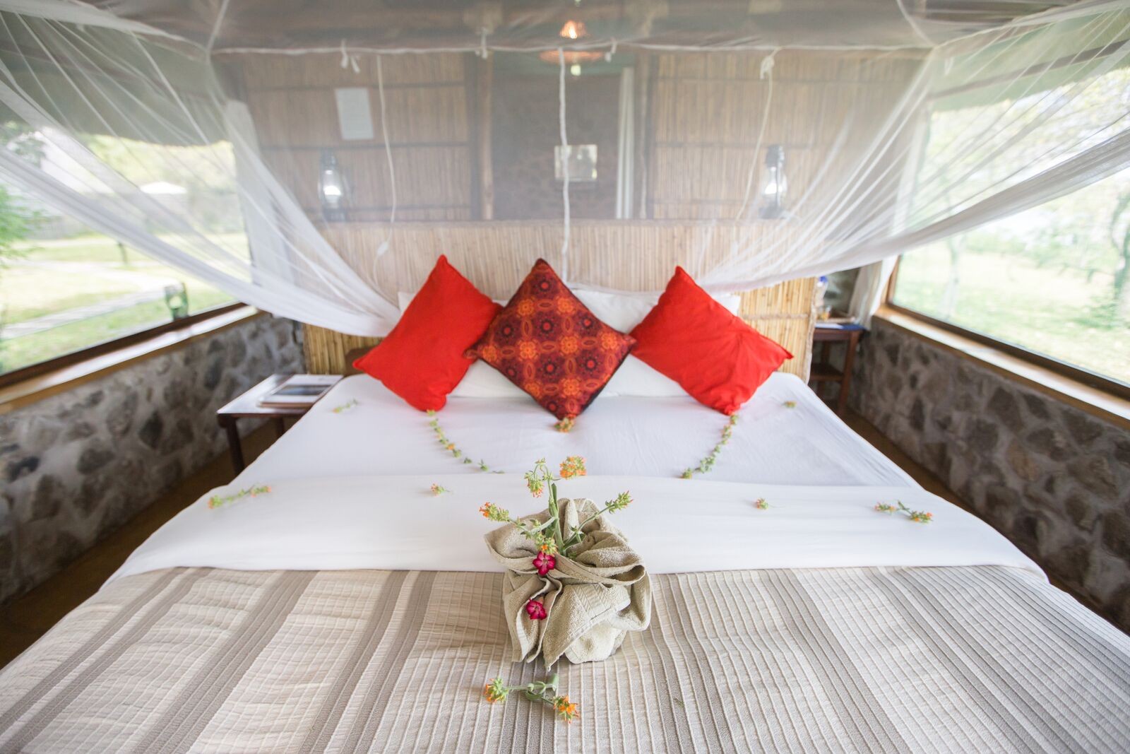 A double bed beneath mosquito netting at Mvuu Camp · Juliet Lemon.
